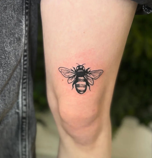 Small Black and Grey Bee on Women Thigh Tattoo by @t1tsfortats