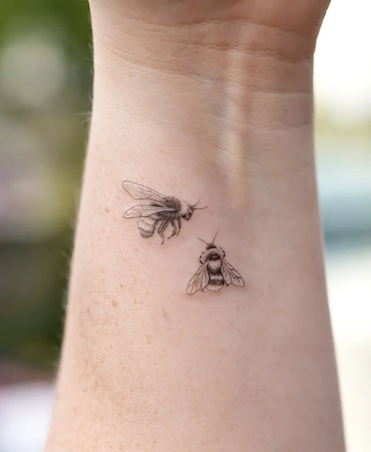 Small Black and Grey Bees on Women Wrist Tattoo by @kathy_tattoo