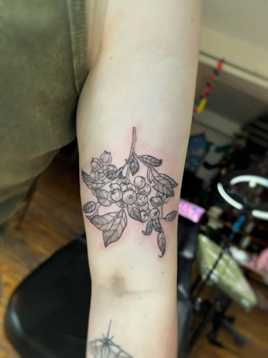 Small Black and Grey Blueberry Branch Tattoo on Women Upper Arm by @valvntin