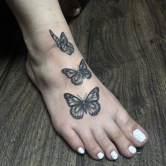 Small Black and Grey Butterfly Trio Tattoo on Women Foot by @ilenadoodles
