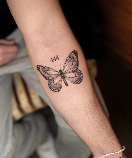Small Black and Grey Butterfly with 444 on Women Arm Tattoo by @zlobina.ink