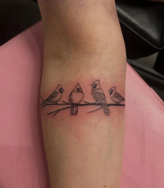 Small Black and Grey Cardinals on Branch Tattoo on Women Arm by @lavender_doomsdaytattoo