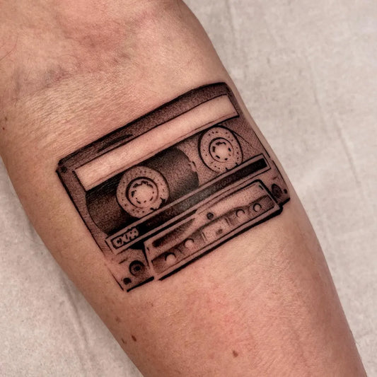 Small Black and Grey Cassette Tape Music Tattoo on Women Forearm by @vik.b.tattoo