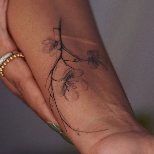 Small Black and Grey Cherry Blossom Branch on Women Arm Tattoo by @jaejari_tattoo