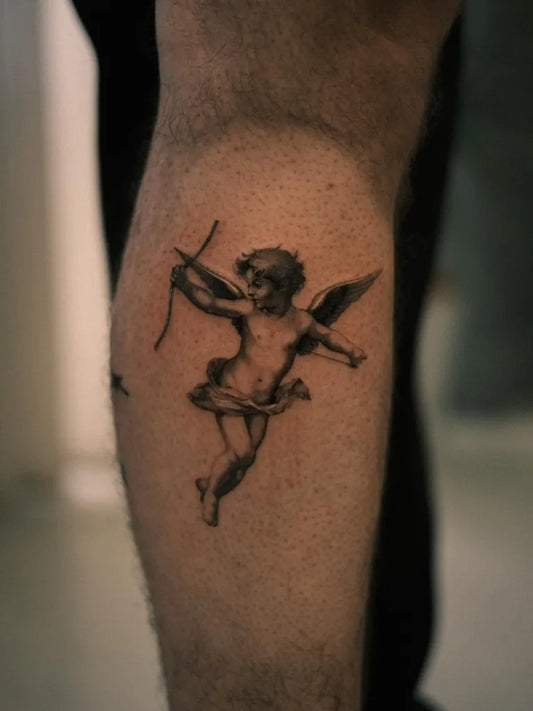Small Black and Grey Cherub Tattoo on Men Leg by @ego.romantic