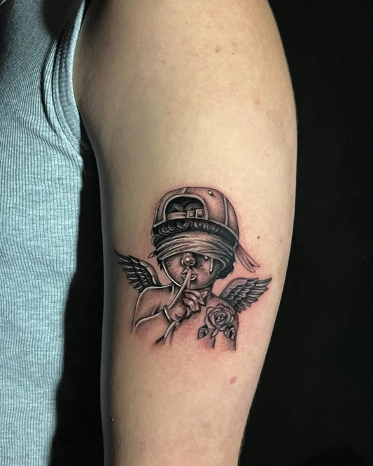 Small Black and Grey Cherub with Bandana and Rose Tattoo on Men Arm by @onismstabz_tattoo