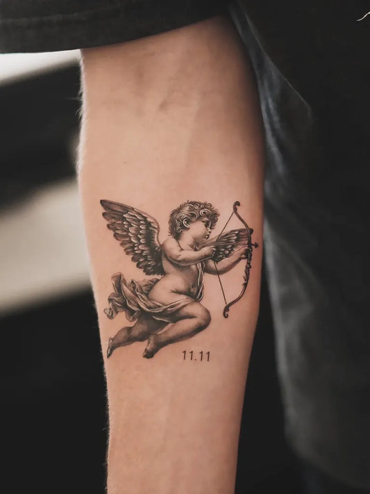 Small Black and Grey Cherub with Bow and Arrow Tattoo on Men Arm by @bentattoo.sh
