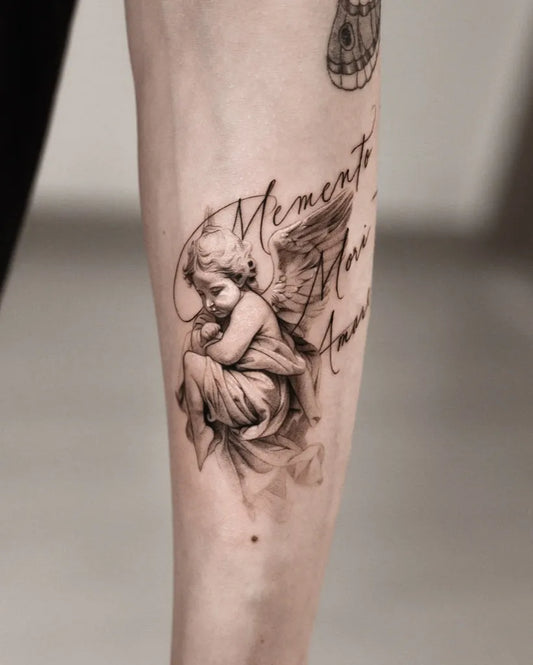 Small Black and Grey Cherub with Wings Tattoo on Women Arm by @oottatjac