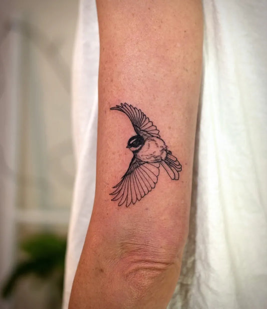 Small Black and Grey Chickadee Bird Tattoo on Women Arm by @vvstattoo