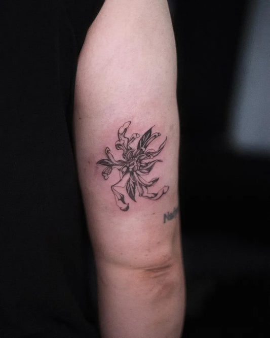 Small Black and Grey Chrysanthemum Tattoo on Women Arm by @juicytatties