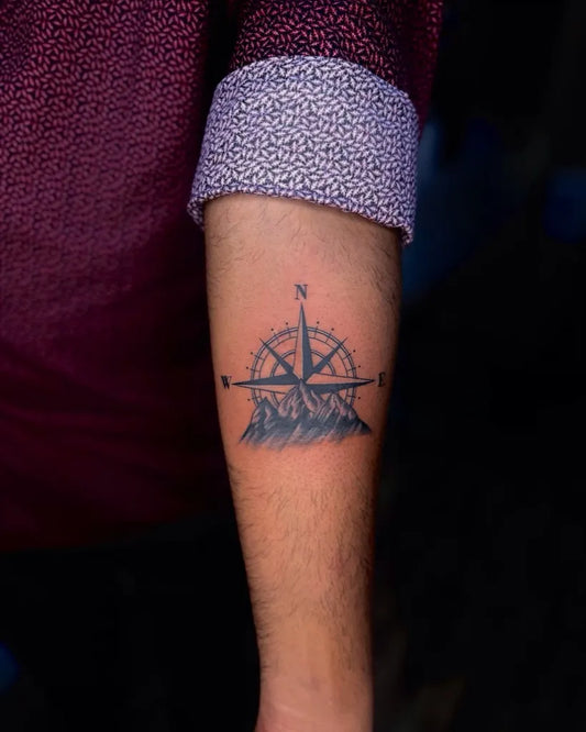 Small Black and Grey Compass with Mountains on Men Arm Tattoo by @rudratattoo