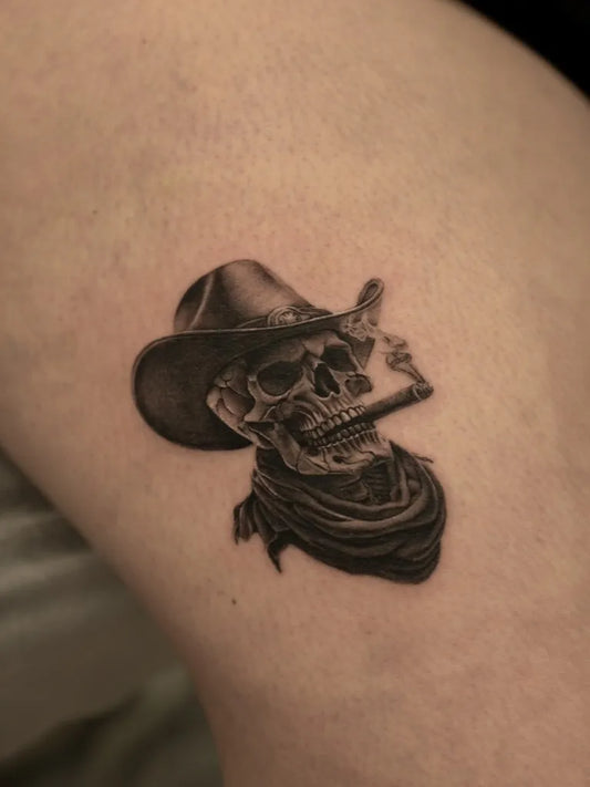 Small Black and Grey Cowboy Skull with Cigar Tattoo on Men Arm by @paulillatats
