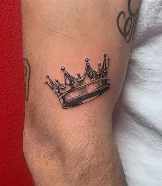 Small Black and Grey Crown Tattoo on Men Arm by @bleed_well_tattoo