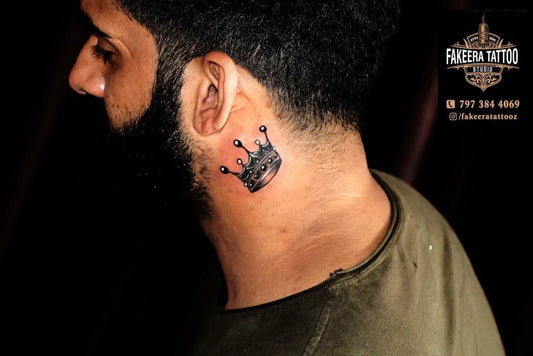 Small Black and Grey Crown Tattoo on Men Neck by @fakeeratattooz