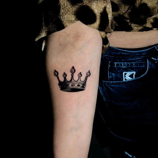 Small Black and Grey Crown Tattoo on Women Arm by @tattoo.sumqayit