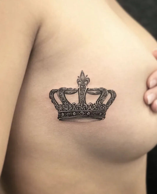 Small Black and Grey Crown Tattoo on Women Chest by @stevenmoreink