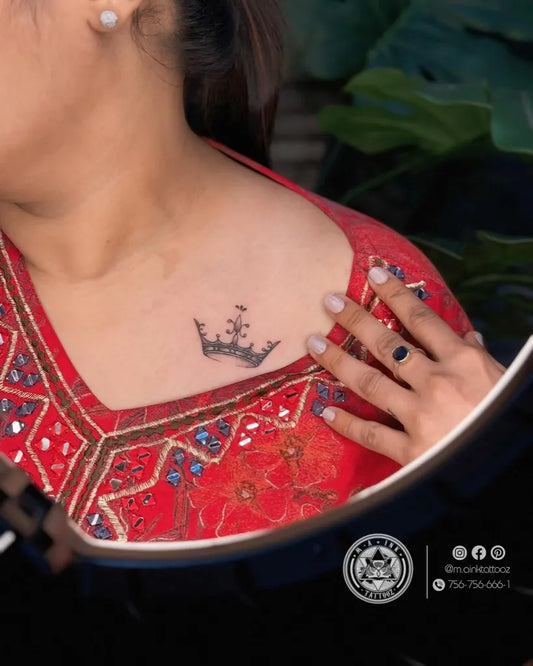 Small Black and Grey Crown Tattoo on Women Shoulder by @m.ainktattooz