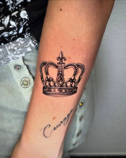 Small Black and Grey Crown and Courage Word Tattoo on Women Arm by @astutogabriele