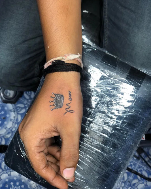Small Black and Grey Crown with Arabic Script Tattoo on Men Wrist by @bombay.tattoo9