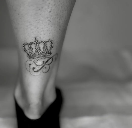 Small Black and Grey Crown with P Initial Tattoo on Women Ankle by @jaded.tattoo.studios