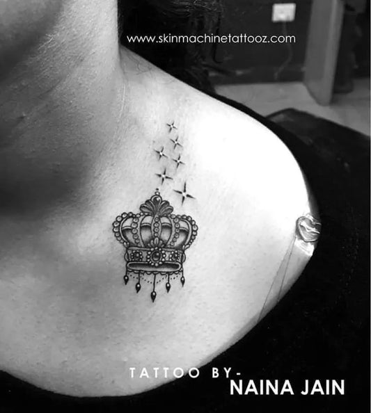 Small Black and Grey Crown with Stars Tattoo on Women Shoulder by @nains_tattoos