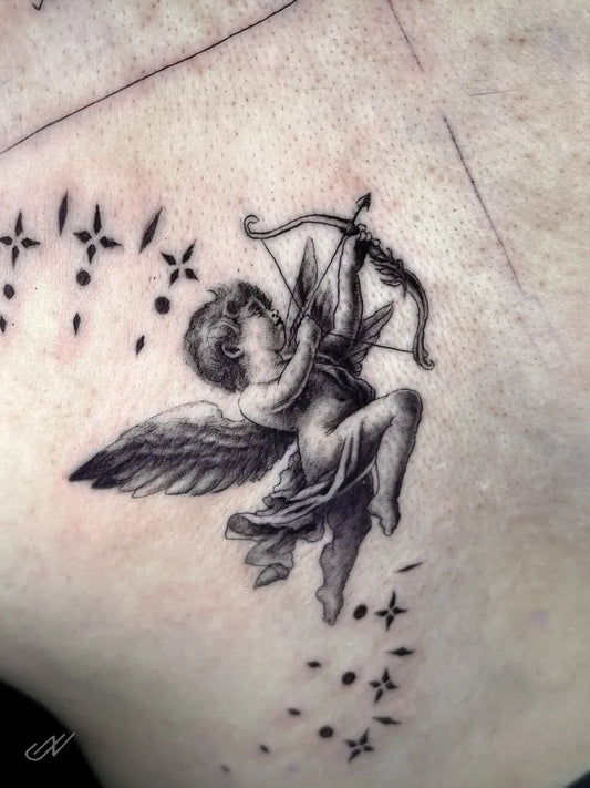 Small Black and Grey Cupid Angel with Bow and Stars on Women Arm Tattoo by @nittitattoos