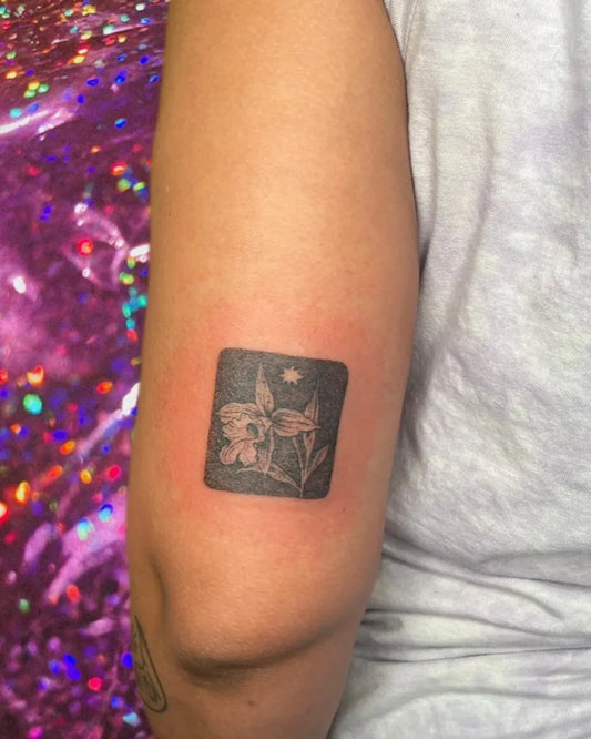 Small Black and Grey Daffodil Tattoo on Women Arm by @little___altars