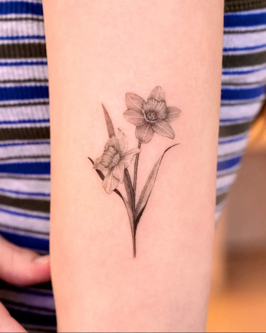 Small Black and Grey Daffodil Tattoo on Women Arm by @tattooist_gaon