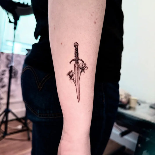 Small Black and Grey Dagger with Flowers Tattoo on Women Forearm by @minu_tattooer