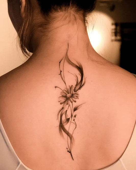 Small Black and Grey Daisy and Vines Tattoo on Women Back by @silvieetattoo