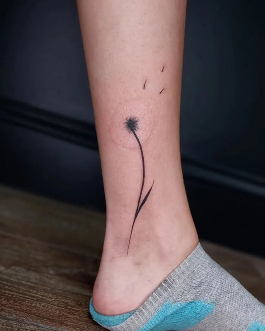 Small Black and Grey Dandelion Tattoo on Women Ankle by @art__by__zaya