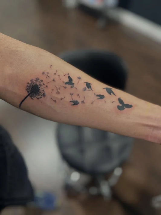 Small Black and Grey Dandelion and Birds Tattoo on Women Arm by @decadenttattoos