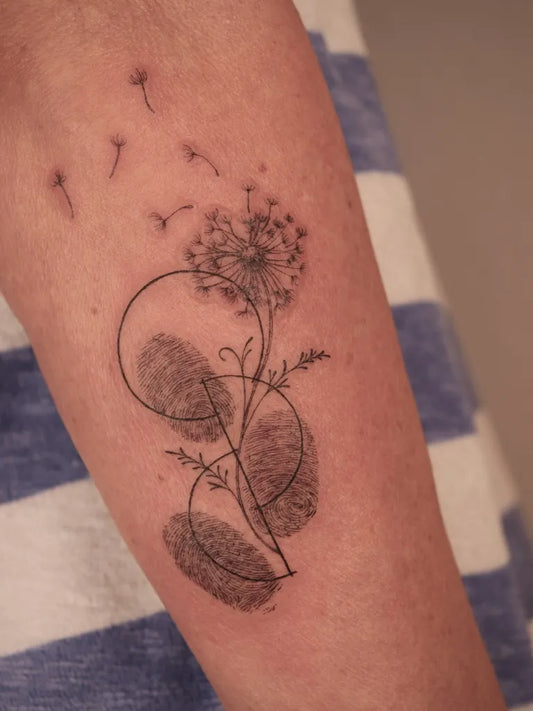 Small Black and Grey Dandelion and Fingerprints Tattoo on Women Arm by @alena.seegers