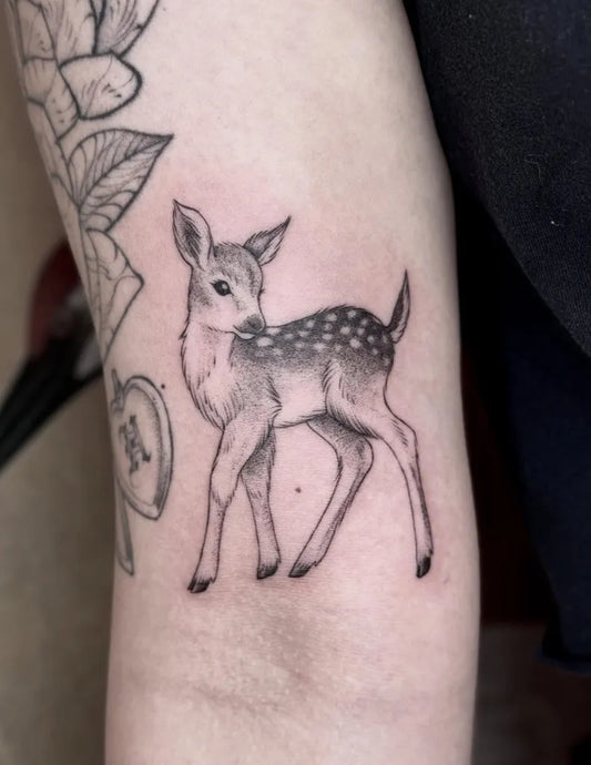 Small Black and Grey Deer Tattoo on Women Arm by @brookelynntattoos