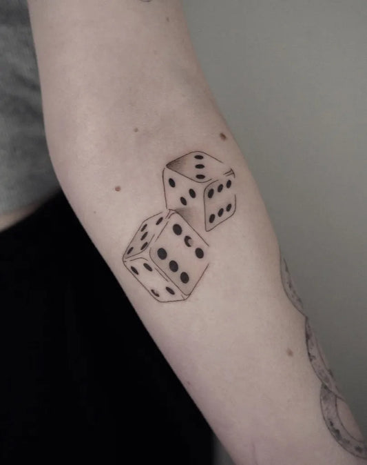 Small Black and Grey Dice Tattoo on Women Arm by @hellymarch_tattoo