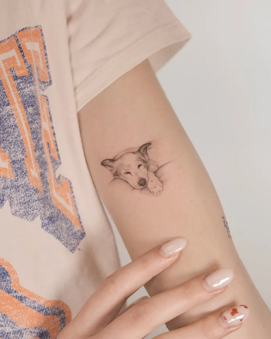 Small Black and Grey Dog Tattoo on Women Arm by @e.lis.tattoo