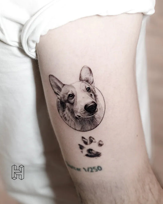 Small Black and Grey Dog and Paw Print Tattoo on Men Arm by @hanzloch.tattoo
