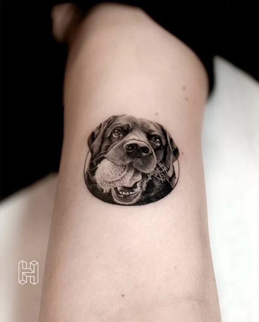 Small Black and Grey Dog with Ball Tattoo on Women Thigh by @hanzloch.tattoo
