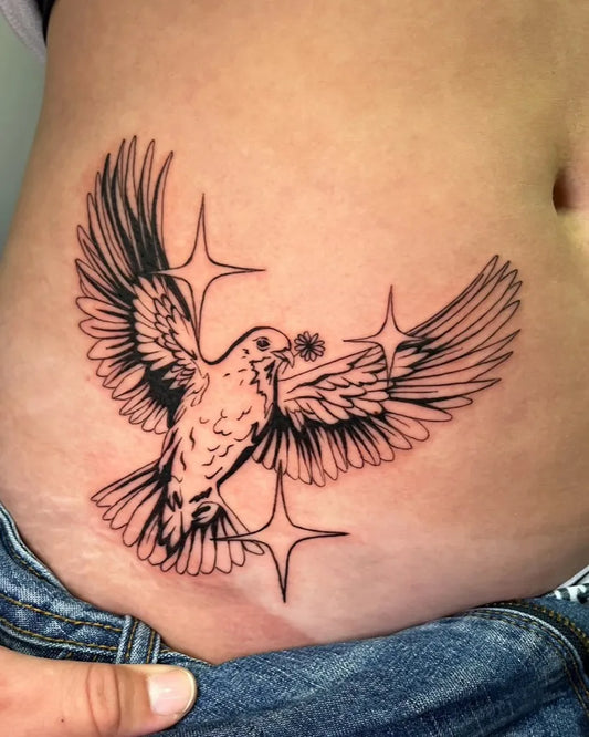 Small Black and Grey Dove with Flower and Stars Tattoo on Women Abdomen by @gamble.tattoos