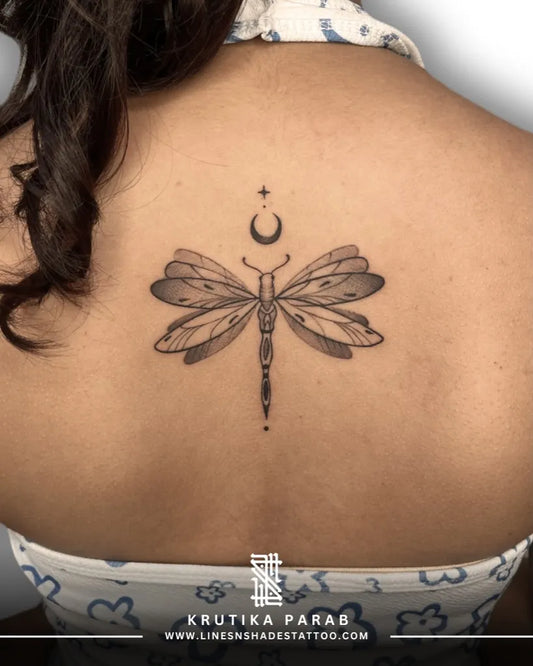 Small Black and Grey Dragonfly Moon Star on Women Back Tattoo by @linesnshadestattoo_studio