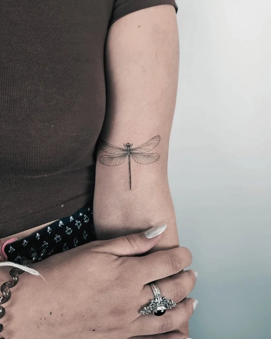 Small Black and Grey Dragonfly on Women Arm Tattoo by @monkeys_factory_tattoo