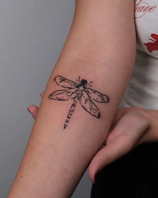 Small Black and Grey Dragonfly on Women Arm Tattoo by @st0rm.ink