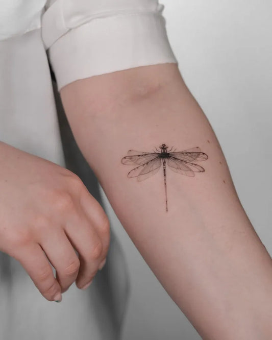 Small Black and Grey Dragonfly on Women Arm Tattoo by @yummymind