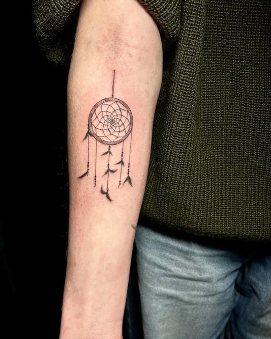 Small Black and Grey Dream Catcher Tattoo on Women Arm by @inky.indy