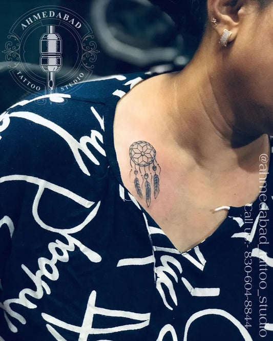 Small Black and Grey Dream Catcher Tattoo on Women Neck by @ahmedabad_tattoo_studio