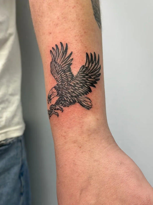 Small Black and Grey Eagle Tattoo on Men Arm by @aj_inkvillage