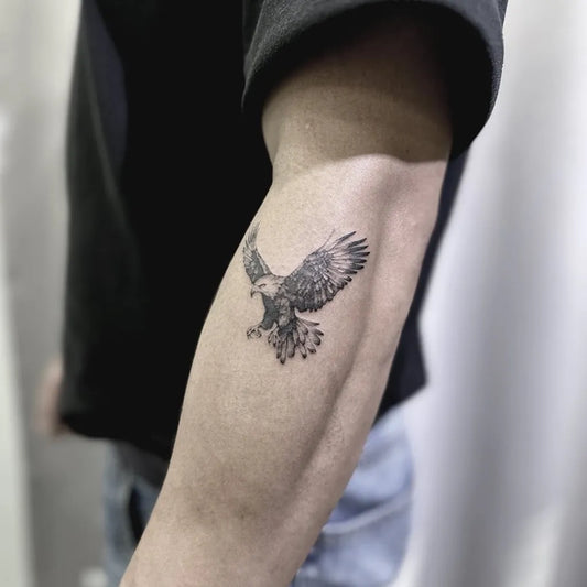 Small Black and Grey Eagle Tattoo on Men Arm by @tattoogo_studio