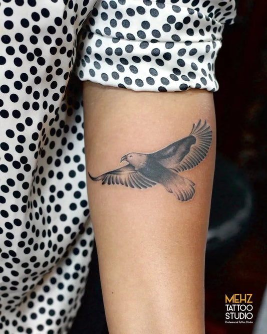 Small Black and Grey Eagle Tattoo on Women Arm by @themehztattoostudio