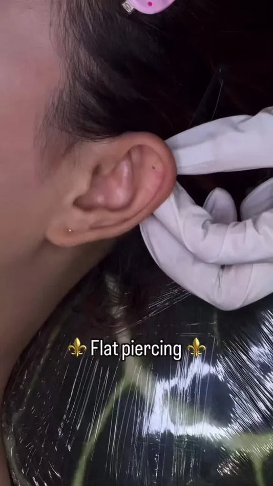 Small Black and Grey Ear Piercing Tattoo on Women Upper Arm by @ctnailslloyd