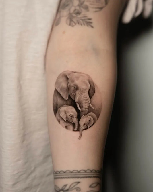 Small Black and Grey Elephant Family Tattoo on Women Arm by @antinktattoo
